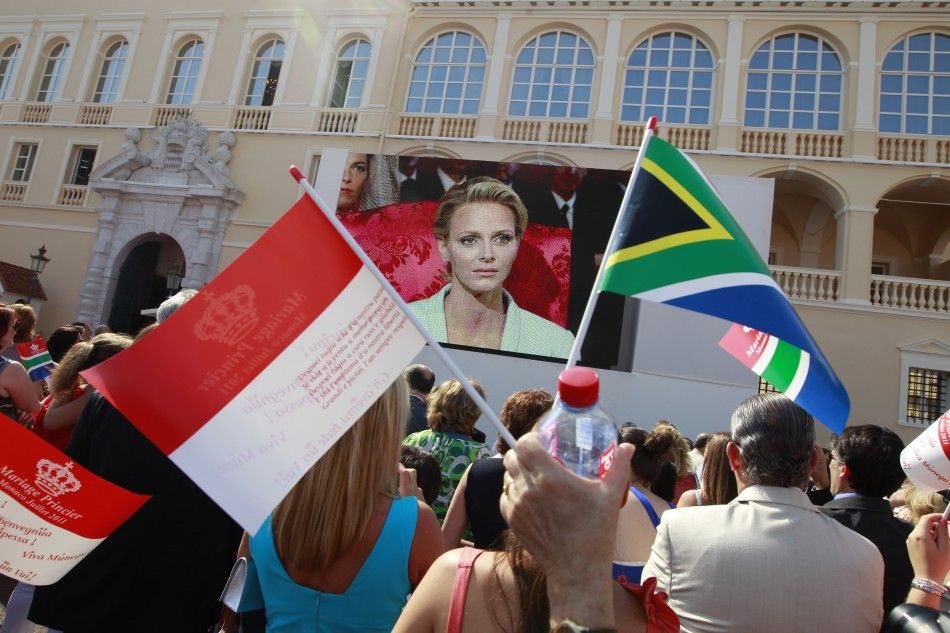 Citizens of Monaco react as they watch a giant screen in the Palace square as Monaco039s Prince Albert II and Princess Charlene are married in a civil wedding service in Monaco