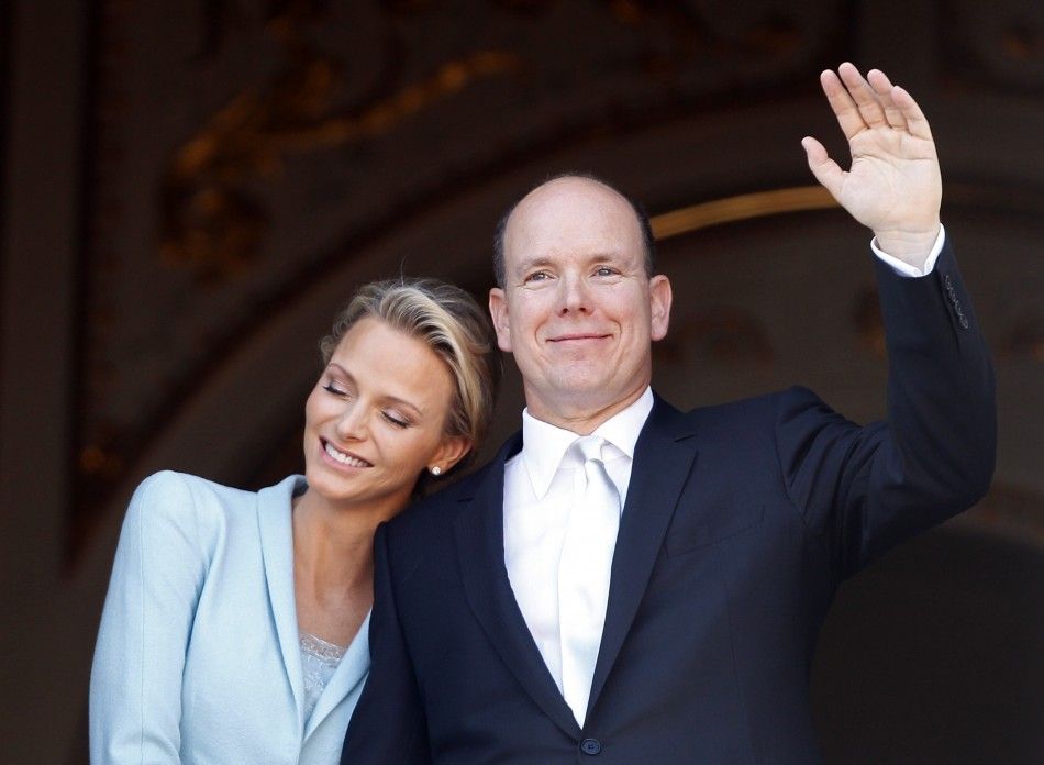 Newlyweds Prince Albert II of Monaco waves as Princess Charlene rests her head on his shoulder on the Palace balcony after the civil wedding service in Monaco