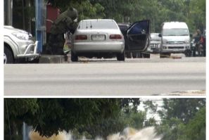 This combination photo shows a car bomb exploding as a member of a Thai bomb squad inspects it in Narathiwat province