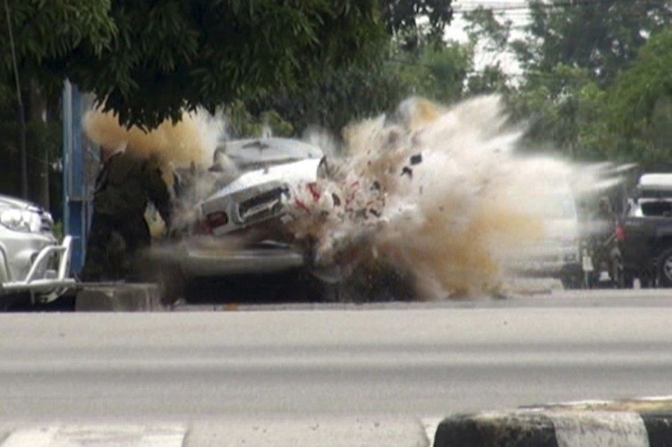 A car bomb explodes as a member of a Thai bomb squad checks it in Narathiwat province