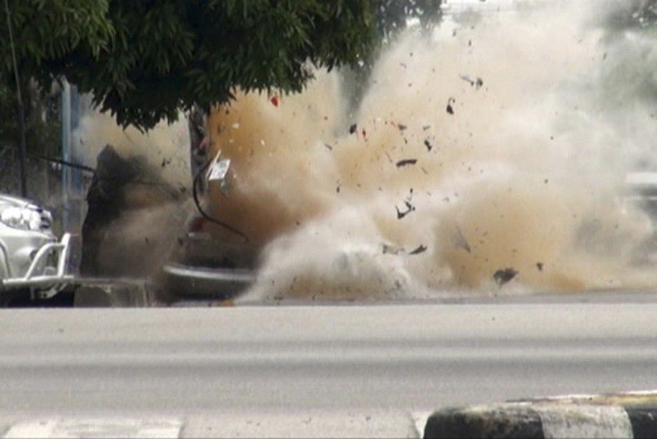 A car bomb explodes as a member of a Thai bomb squad checks it in Narathiwat province