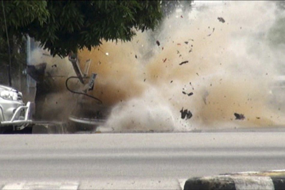 A car bomb explodes as a member of a Thai bomb squad checks it in Narathiwat province