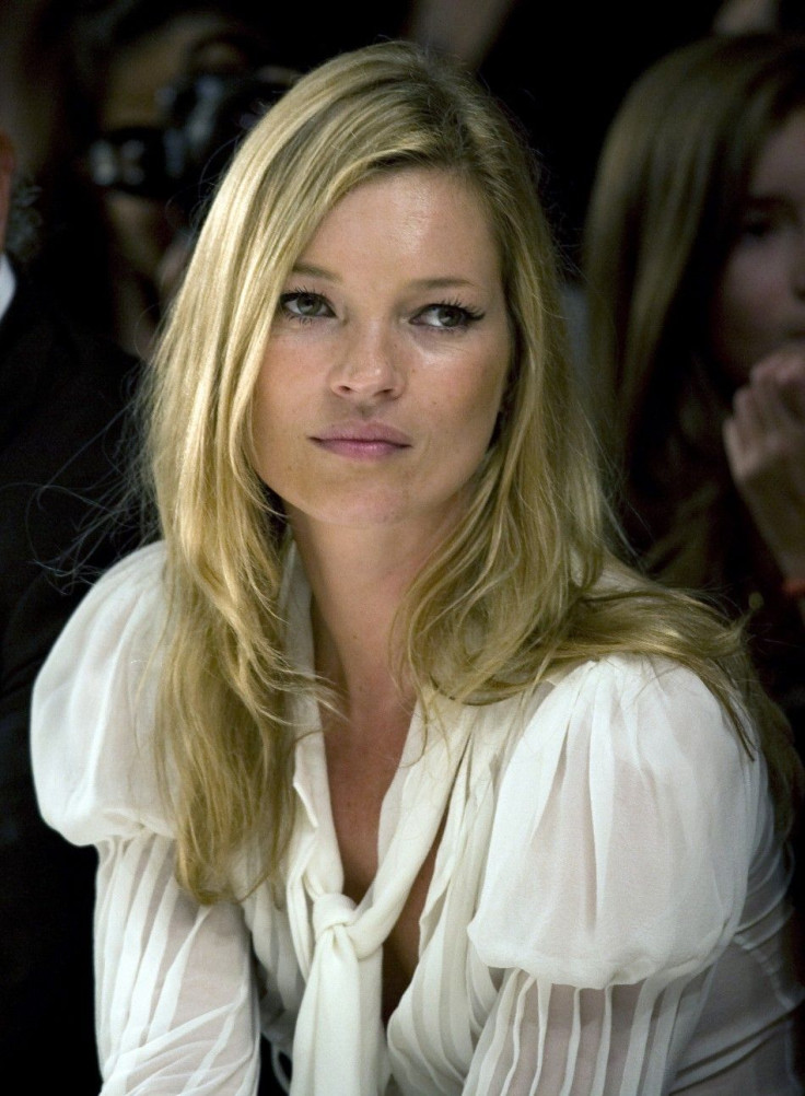 Super model Kate Moss watches the Fashion for Relief charity fashion show in London