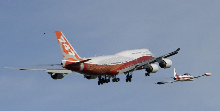 The Boeing 747-8 Intercontinental is followed by a chase plane after taking off on its maiden flight from Paine Field, in Everett, Washington