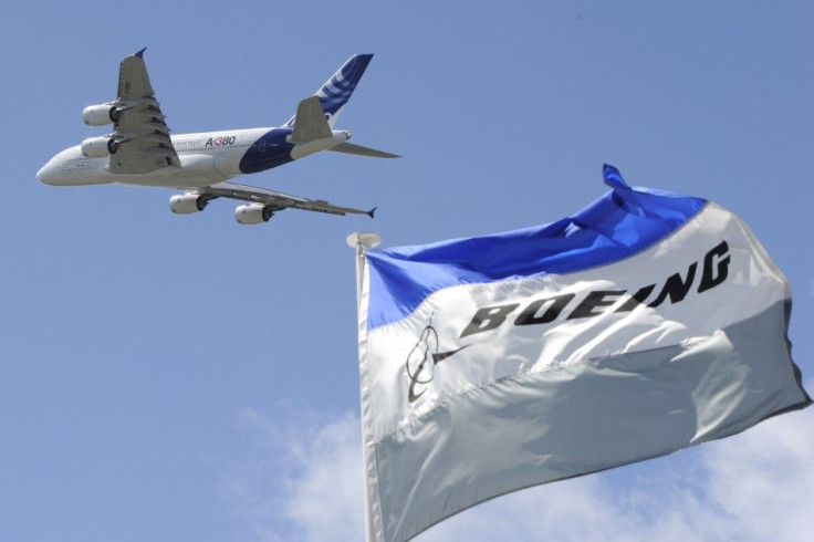 Boeing flags flutter as an Airbus A380, the world&#039;s largest jetliner, takes part in a flying display during the 49th Paris Air Show at the Le Bourget airport near Paris