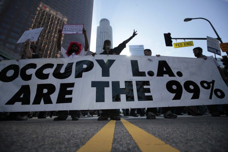 Protesters march with a large banner outside a Bank of America office at an Occupy LA protest in Los Angeles, California