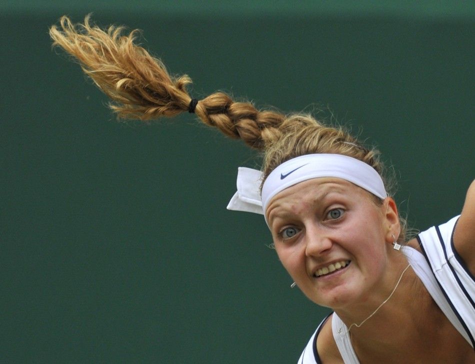Petra Kvitova of the Czech Republic serves to Maria Sharapova of Russia during their final match at the Wimbledon tennis championships in London