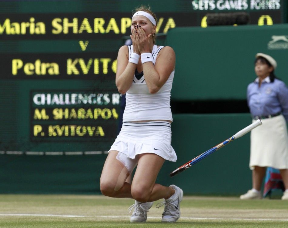 Petra Kvitova of the Czech Republic celebrates after defeating Maria Sharapova of Russia in their final match at the Wimbledon tennis championships in London