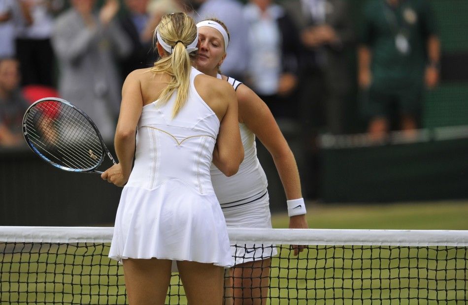 Petra Kvitova of the Czech Republic kisses Maria Sharapova of Russia after defeating her in their final match at the Wimbledon tennis championships in London
