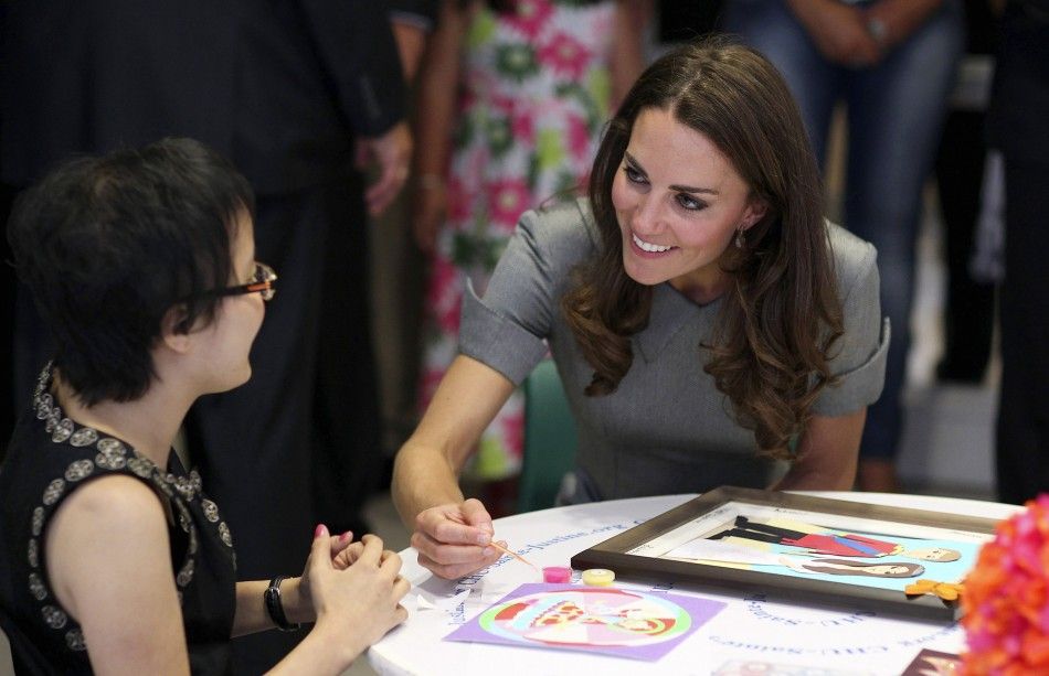 Catherine, Duchess of Cambridge, smiles at a patient during a tour of the Sainte-Justine Hospital in Montreal