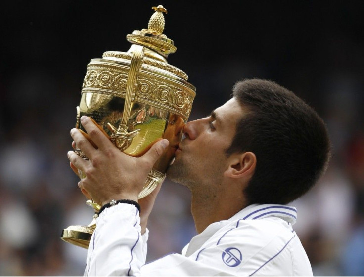 Novak Djokovic of Serbia kisses the winners trophy after defeating Rafael Nadal of Spain in the men's singles final at the Wimbledon tennis championships in London.
