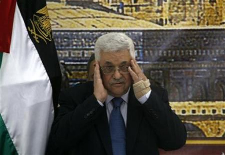 Palestinian President Mahmoud Abbas prays before the start of a meeting in Ramallah