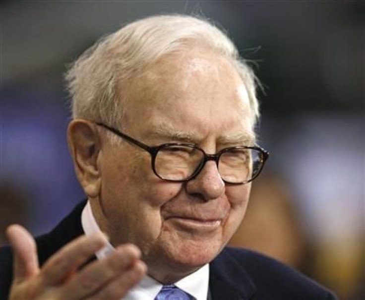 Warren Buffett talks with a reporter at the Berkshire Hathaway annual meeting