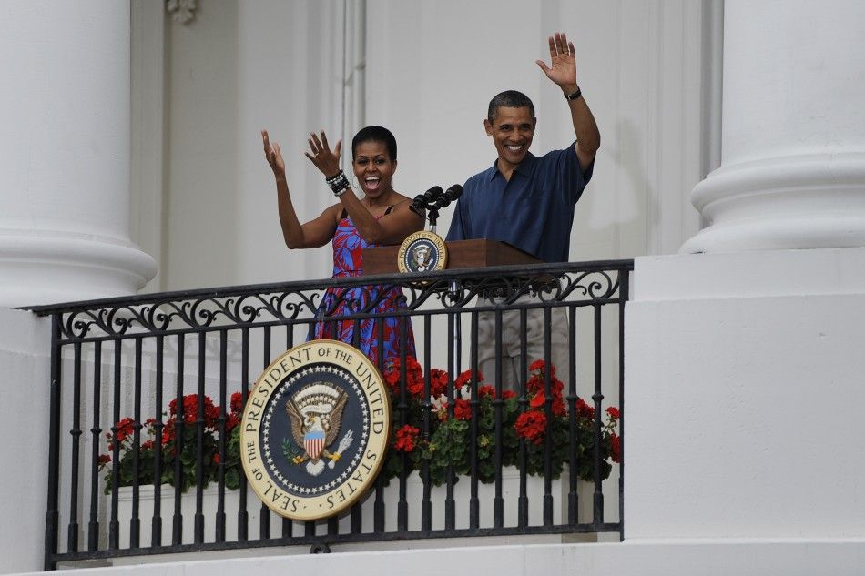 U.S. President Barack Obama and his wife Michelle arrive to make remarks at an Independence Day barbeque at the White House in Washington