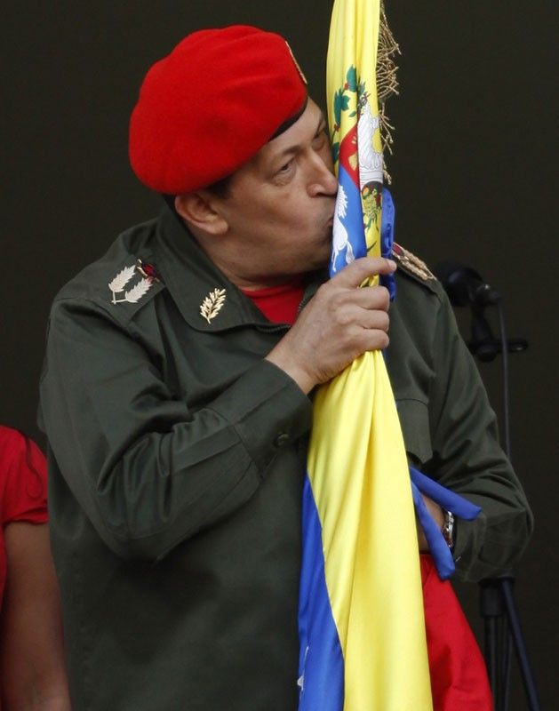 Venezuelas President Hugo Chavez kisses the national flag 