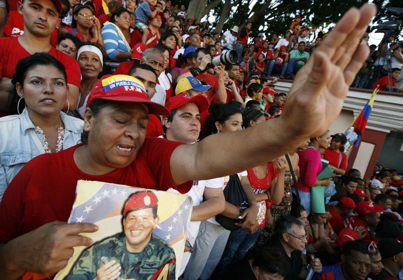 Supporters of Venezuelas President Hugo Chavez await his appearance in front of Miraflores Palace