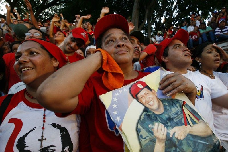 Supporters of Venezuelas President Hugo Chavez await his appearance in front of Miraflores Palace 