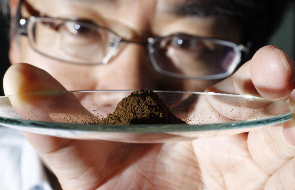 Kato, an associate professor of earth science at the University of Tokyo, displays a mud sample extracted from the depths of about 4,000 metres 13,123 ft below the Pacific ocean surface in Tokyo