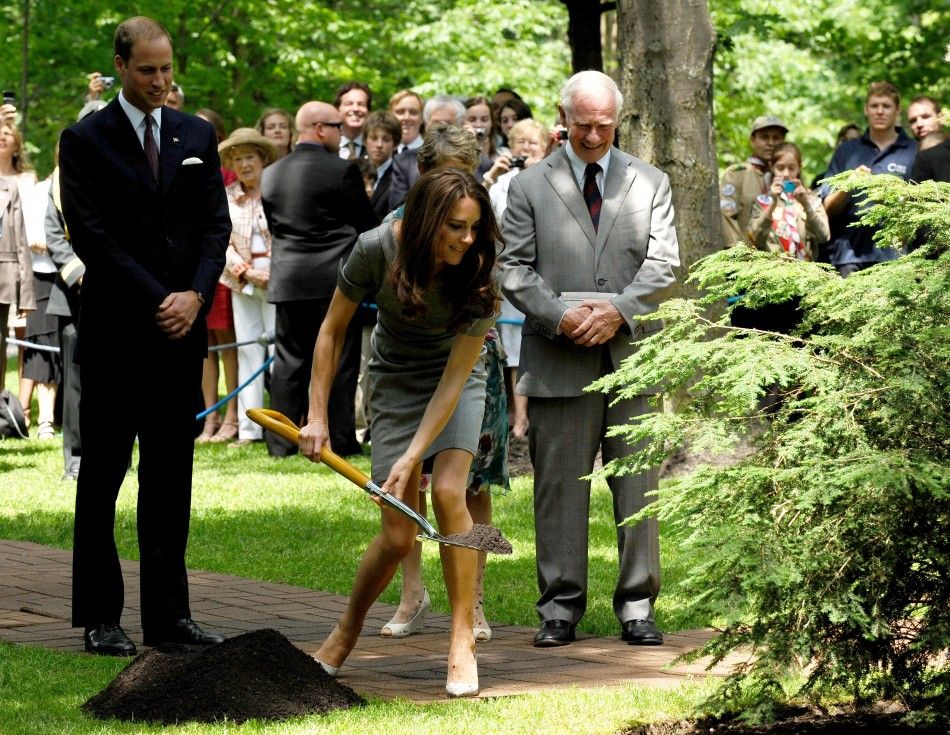 Britain039s Prince William L watches as his wife Catherine, Duchess of Cambridge wields a shovel to plant a tree at Rideau Hall in Ottawa July 2, 2011