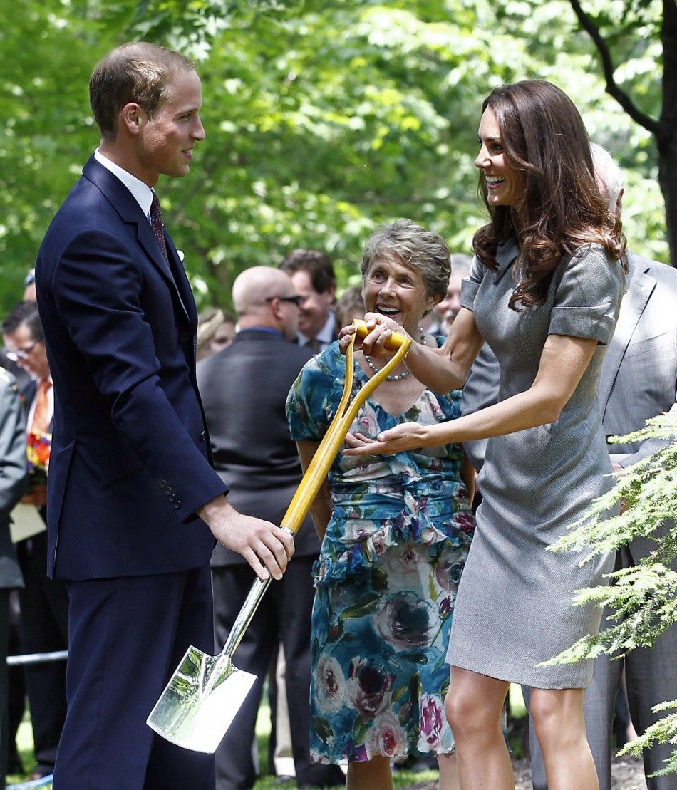 Britain039s Prince William hands his wife Catherine, Duchess of Cambridge, a shovel during a tree planting ceremony at Rideau Hall in Ottawa July 2, 2011.