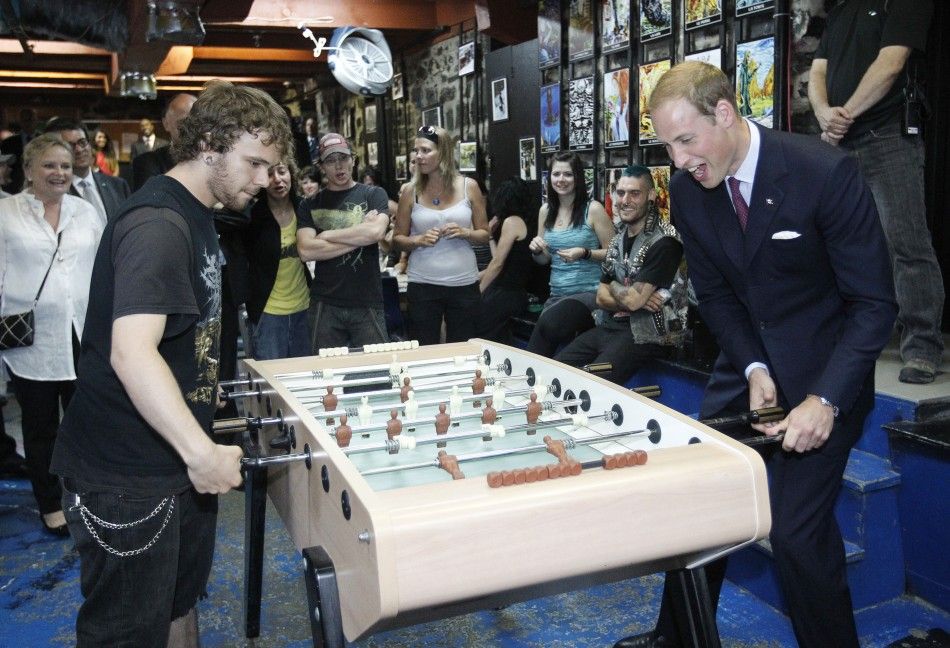 Britain039s Prince William plays table soccer during a tour of the Maison Dauphine in Quebec City July 3, 2011.