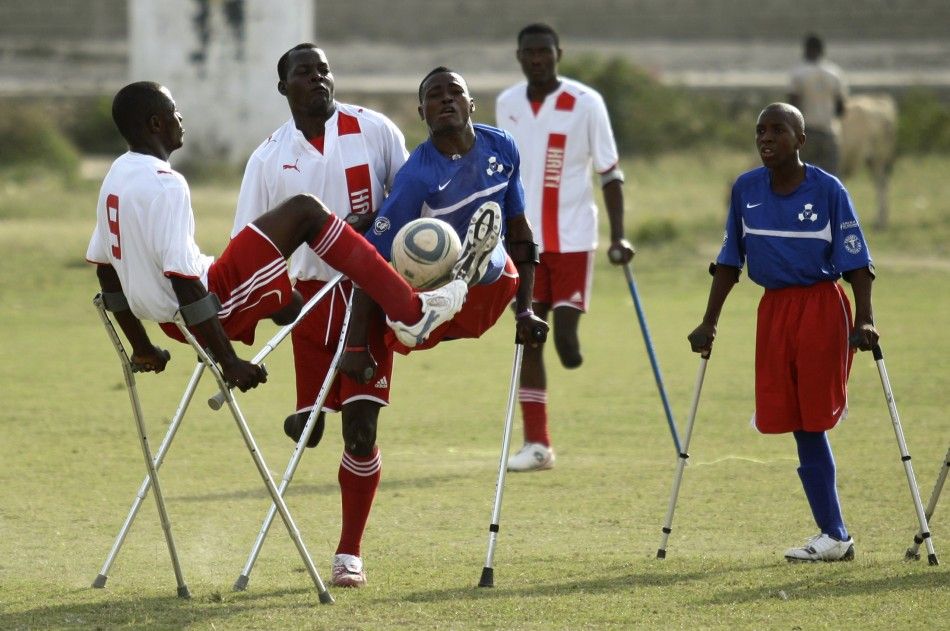 Haitian soccer players of the Zaryen team and the National amputee team fight for the ball during a friendly match in Port-au-Prince