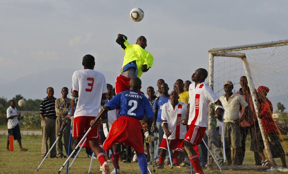 Haitian national amputee team goalkeeper stops the ball from players of the Zaryen team during a friendly match in Port-au-Prince