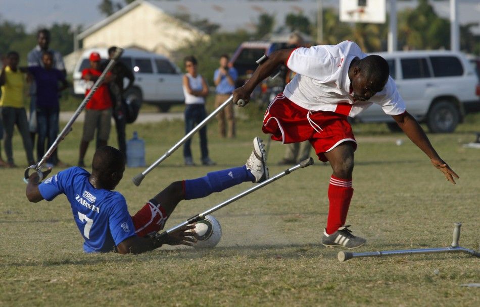 Soccer players of the Zaryen team blue and the national amputee team white fight for the ball during a friendly match in Port-au-Prince