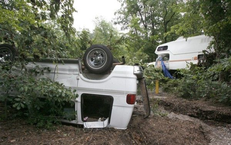 An over-turned van and a damaged vehicle are seen near the Little Missouri river bed at the Albert Pike recreation area near Caddo Gap, Arkansas June 12, 2010. 
