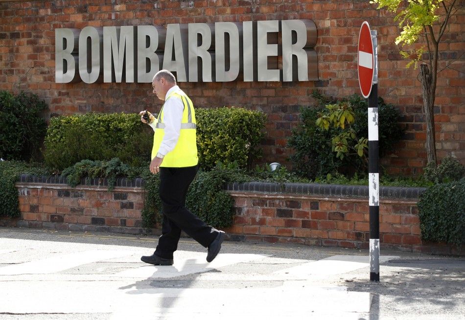 A worker walks past the entrance to the Bombardier plant in Derby