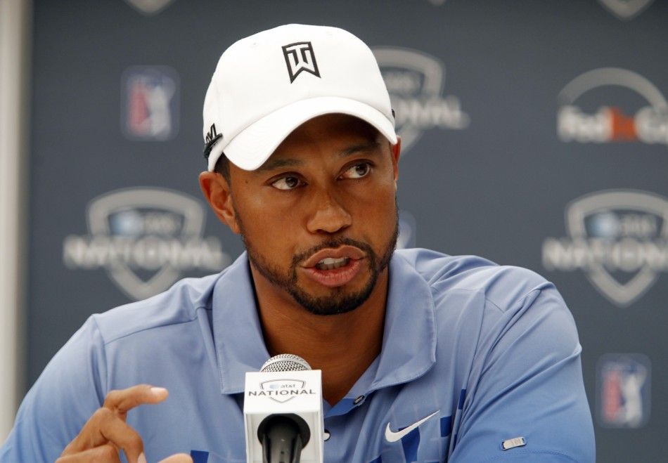 Tiger Woods answers questions during a news conference before the start of the ATT National golf tournament at the Aronimink Golf course