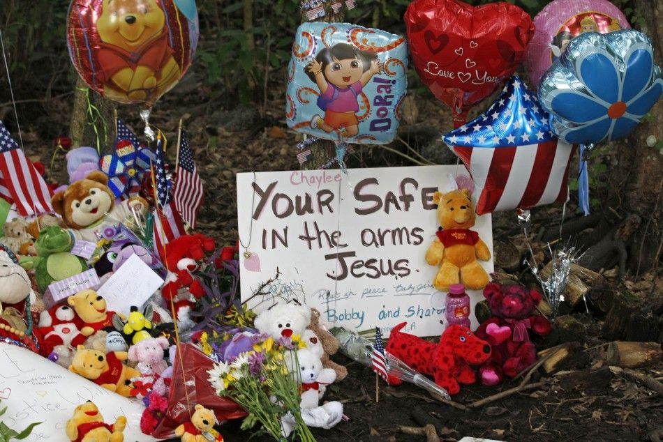 Balloons and toy teddy bears sit at the wooded location of where the body of Caylee Anthony was found in 2008