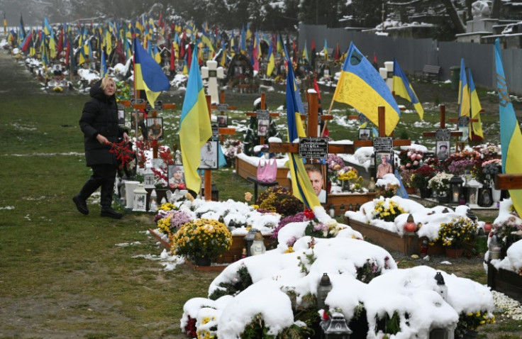 A local resident visits soldiers' graves on the Day of Dignity and Freedom at the Lychakiv Cemetery in Lviv, western Ukraine
