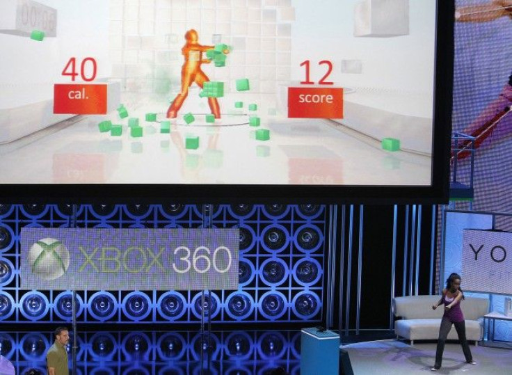 An assistant demonstrates the game &quot;Your Shape: Fitness Evolved&quot; for Kinect for Xbox 360 during a media briefing in Los Angeles. 