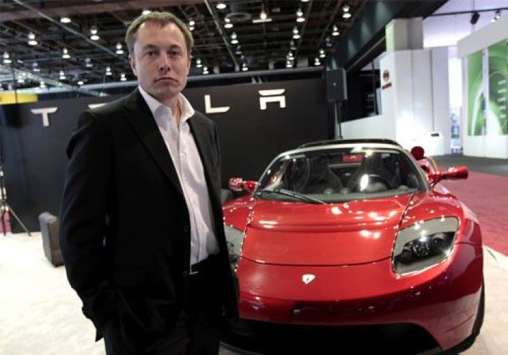Tesla CEO Elon Musk stands in front of the Tesla Roadster