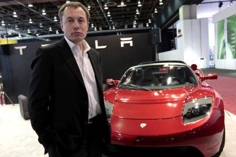 Tesla CEO Elon Musk stands in front of the Tesla Roadster