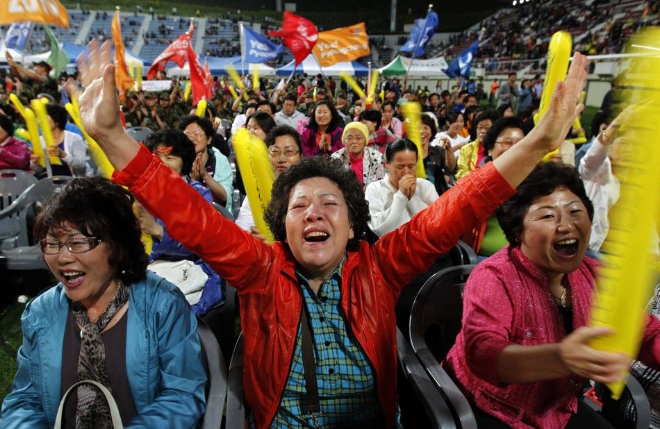 South Koreans react as they hear that Pyeongchang would win in a first round of voting
