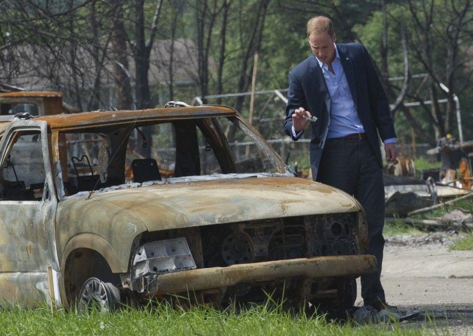Britain039s Prince William looks at the damage caused by a forest fire in Slave Lake, Alberta