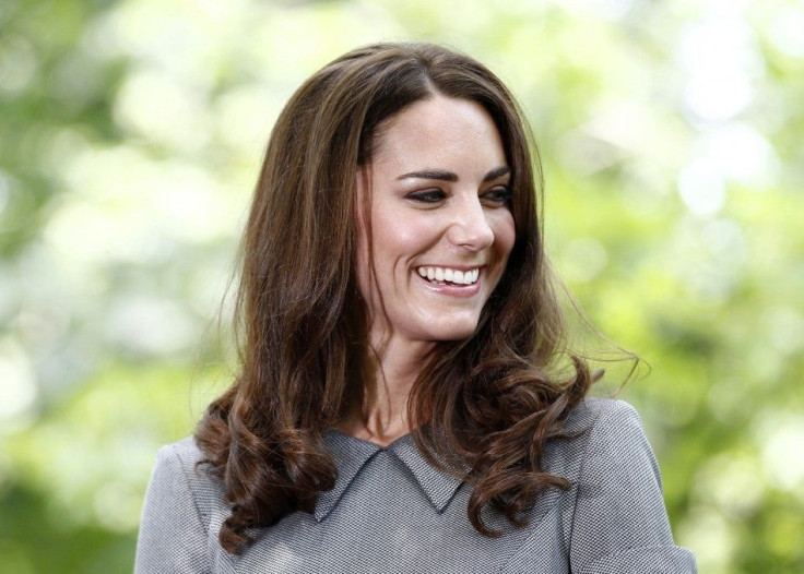Catherine, Duchess of Cambridge, laughs during a tree planting ceremony