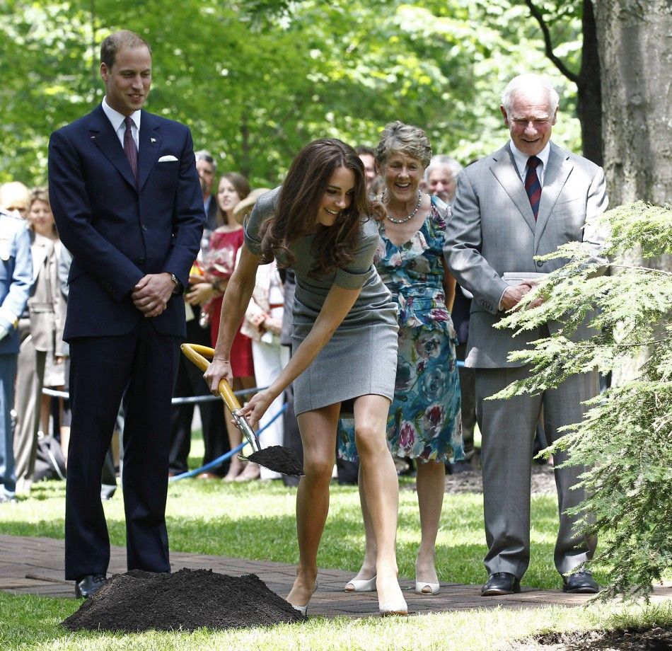 Britain039s Prince William watches as his wife Catherine, Duchess of Cambridge, shovels dirt