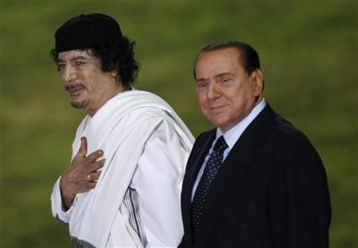 Italy&quot;s Prime Minister Silvio Berlusconi and Libyan leader Muammar Gaddafi (L)