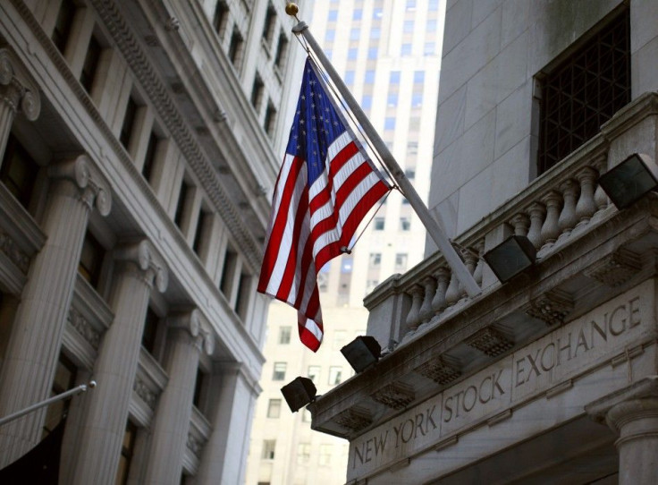 A U.S. flag flies outside an entrance to the New York Stock Exchange