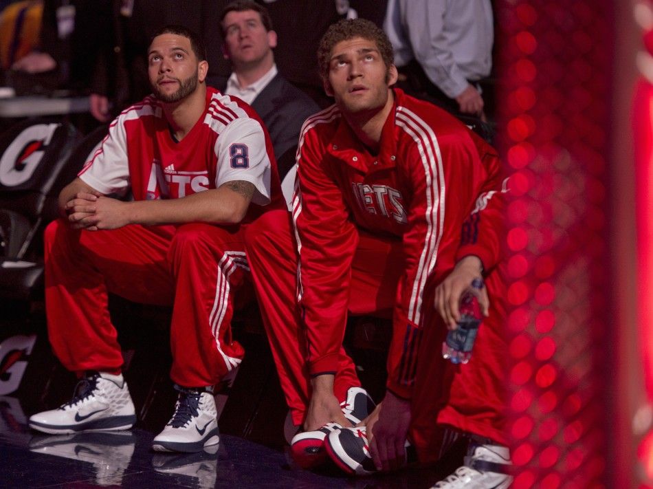 New Jersey Nets guard Deron Williams and his new teammate center Brook Lopez wait during the introduction ceremony befor