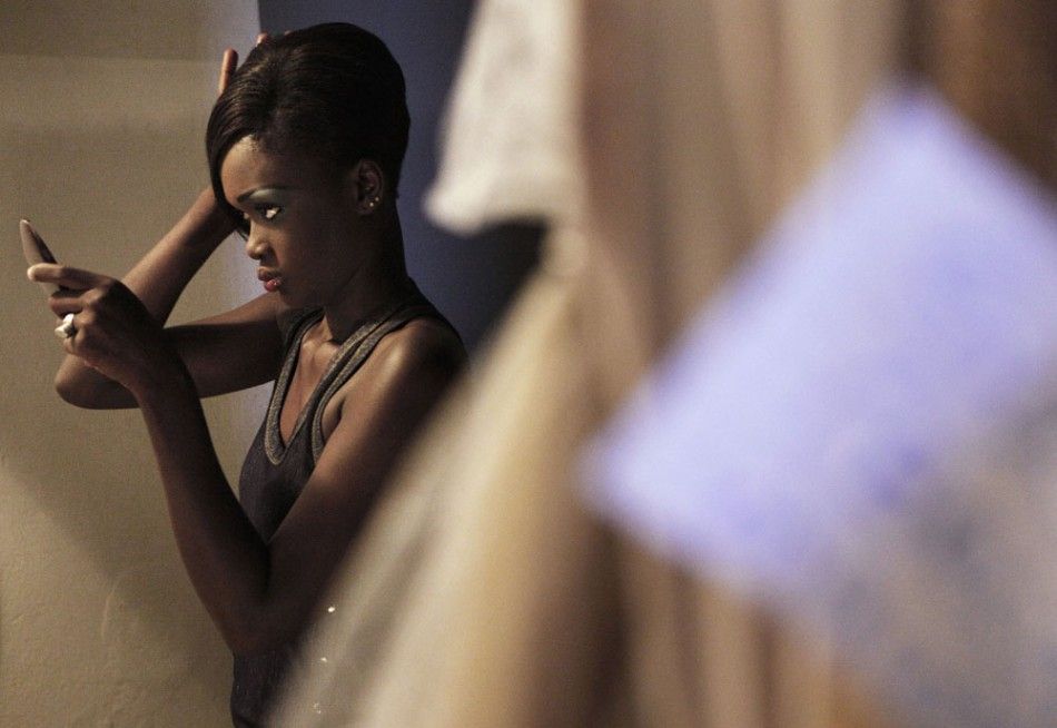 A Senegalese model checks her hair backstage