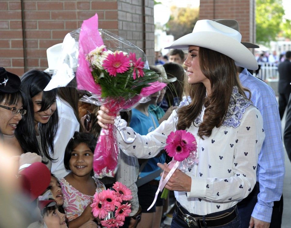 Catherine, Duchess of Cambridge, gets flowers from fans at the Calgary Stampede in Calgary.