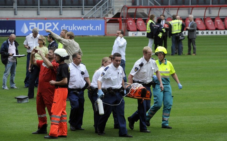 Aid workers carry out a victim after the collapse of a part of a newly constructed roof at the soccer stadium of FC Twente Enschede in Enschede.
