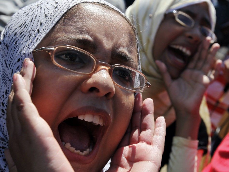 Demonstraters chant slogans against police outside court building during trial of two police officers in Alexandria