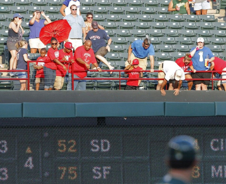 Rangers fans react to another fan, Shannon Stone, falling after trying to reach a foul ball.