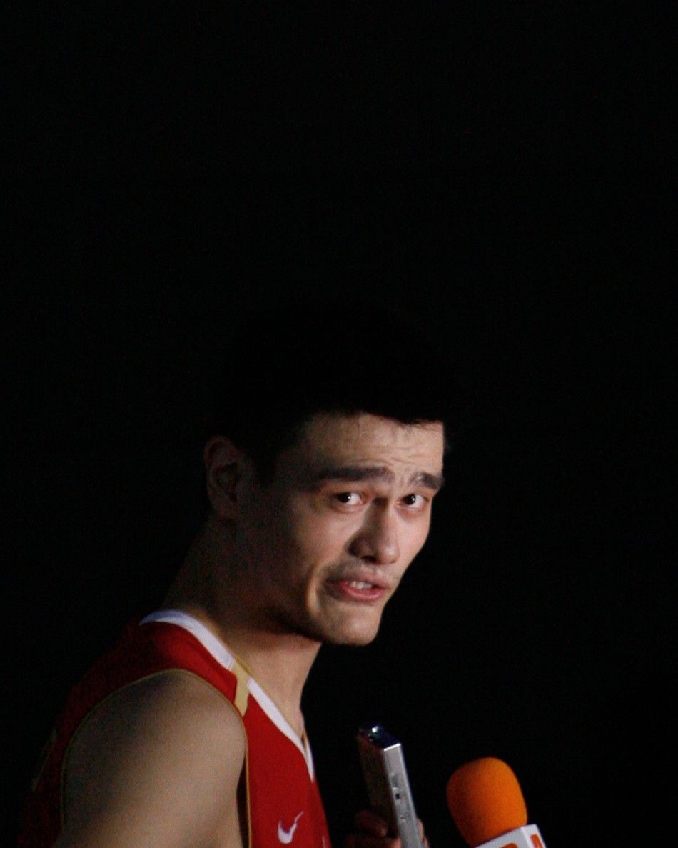 Chinas Yao talks with reporters after loss against Greece during their world basketball championships game in Saitama
