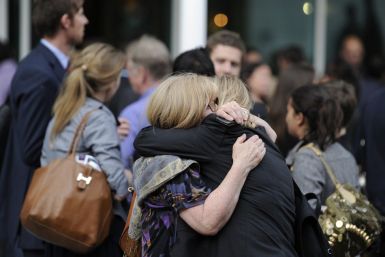 Two members of The News of The World staff hug outside a public house close to News International offices in Wapping